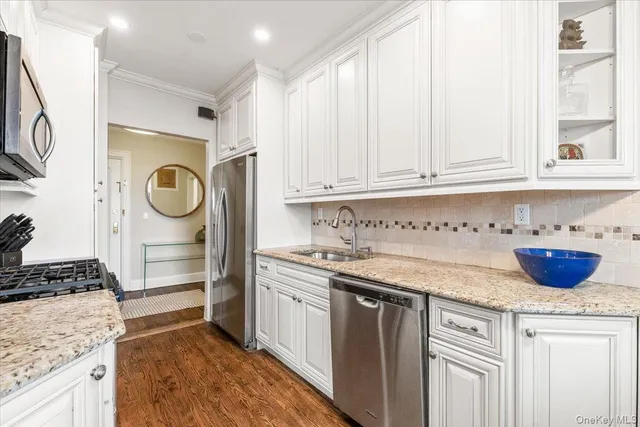 a kitchen with stainless steel appliances granite countertop a sink and a stove