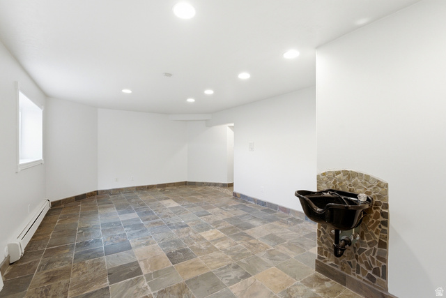 3535 Homestead Road Park City, UT 84098 - Photo 62 of 81 Spacious room featuring slate-style tile flooring, recessed ceiling lighting, a wall-mounted basin with stone tile surround, and white painted walls