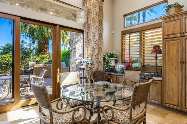 a view of a dining room with furniture window and outside view