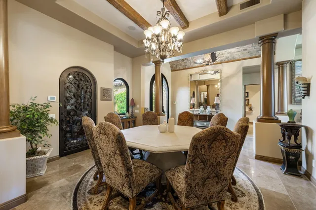 a view of a dining room with furniture and chandelier