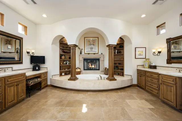 a living room with fireplace furniture and a flat screen tv