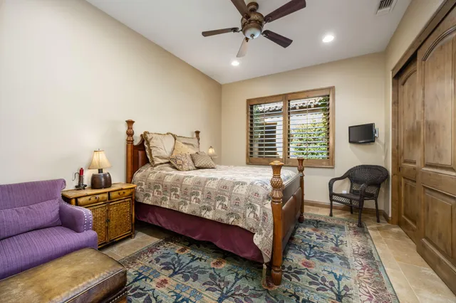 a bedroom with a bed wooden floor and furniture