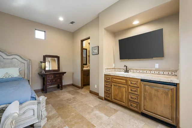 a hotel room with a bed and a flat screen tv