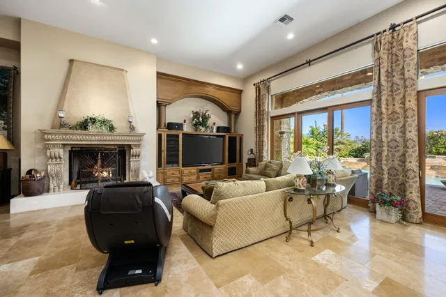 a living room with furniture large window and a fireplace