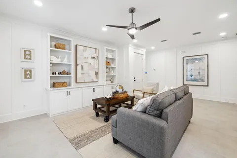 a bathroom with a double vanity sink a toilet and shower