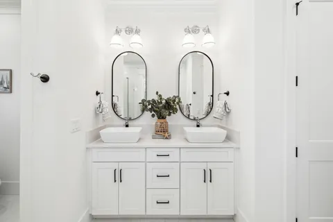 a kitchen with white cabinets and appliances