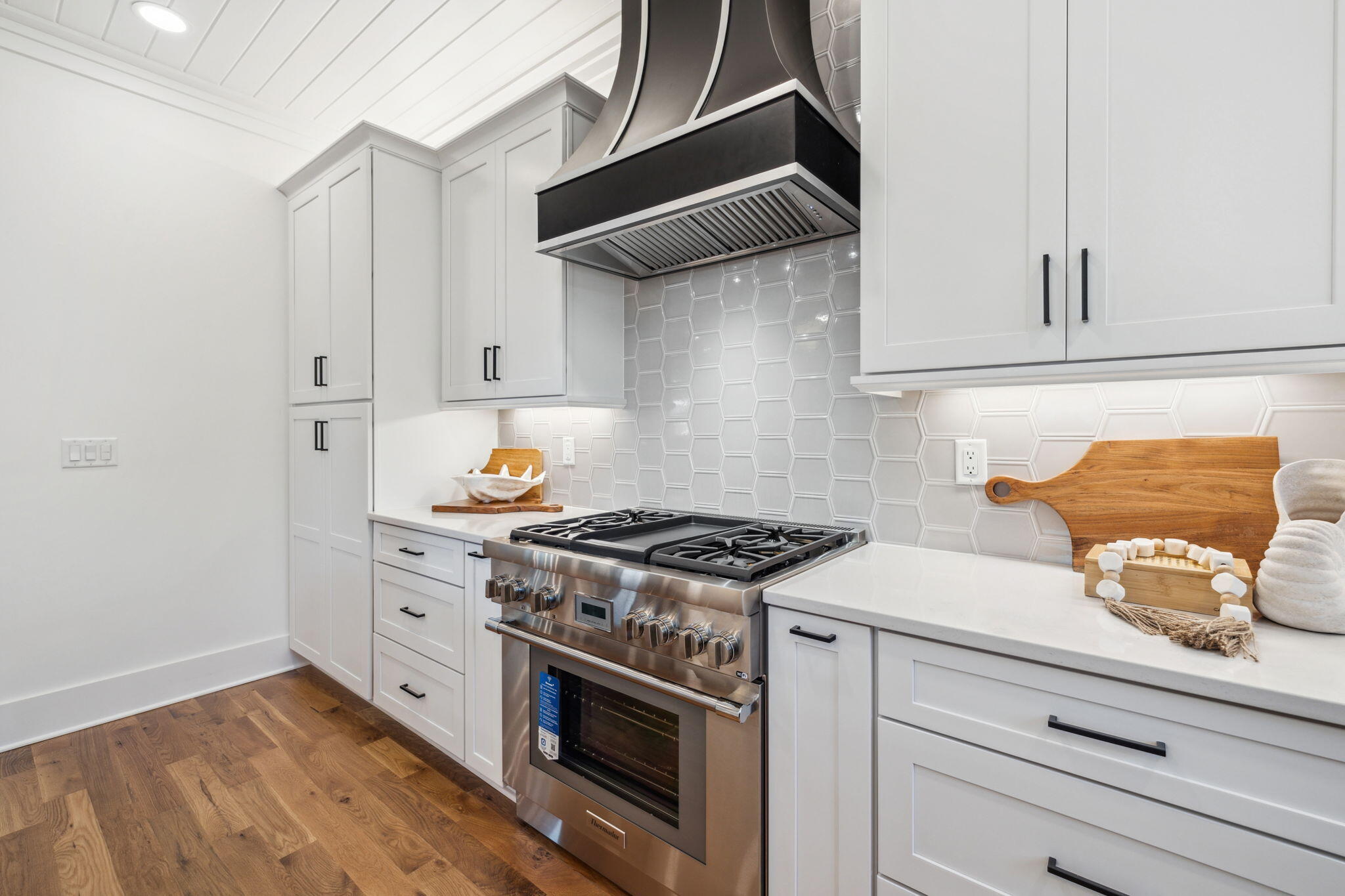200 Grayton Boulevard Santa Rosa Beach, FL 32459 - Photo 23 of 55 a kitchen with white cabinets and appliances