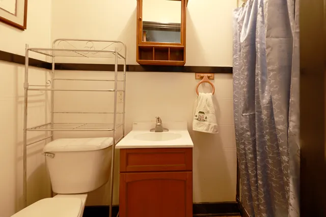 a bed sitting in a bedroom next to a window with a flat screen tv and a couch