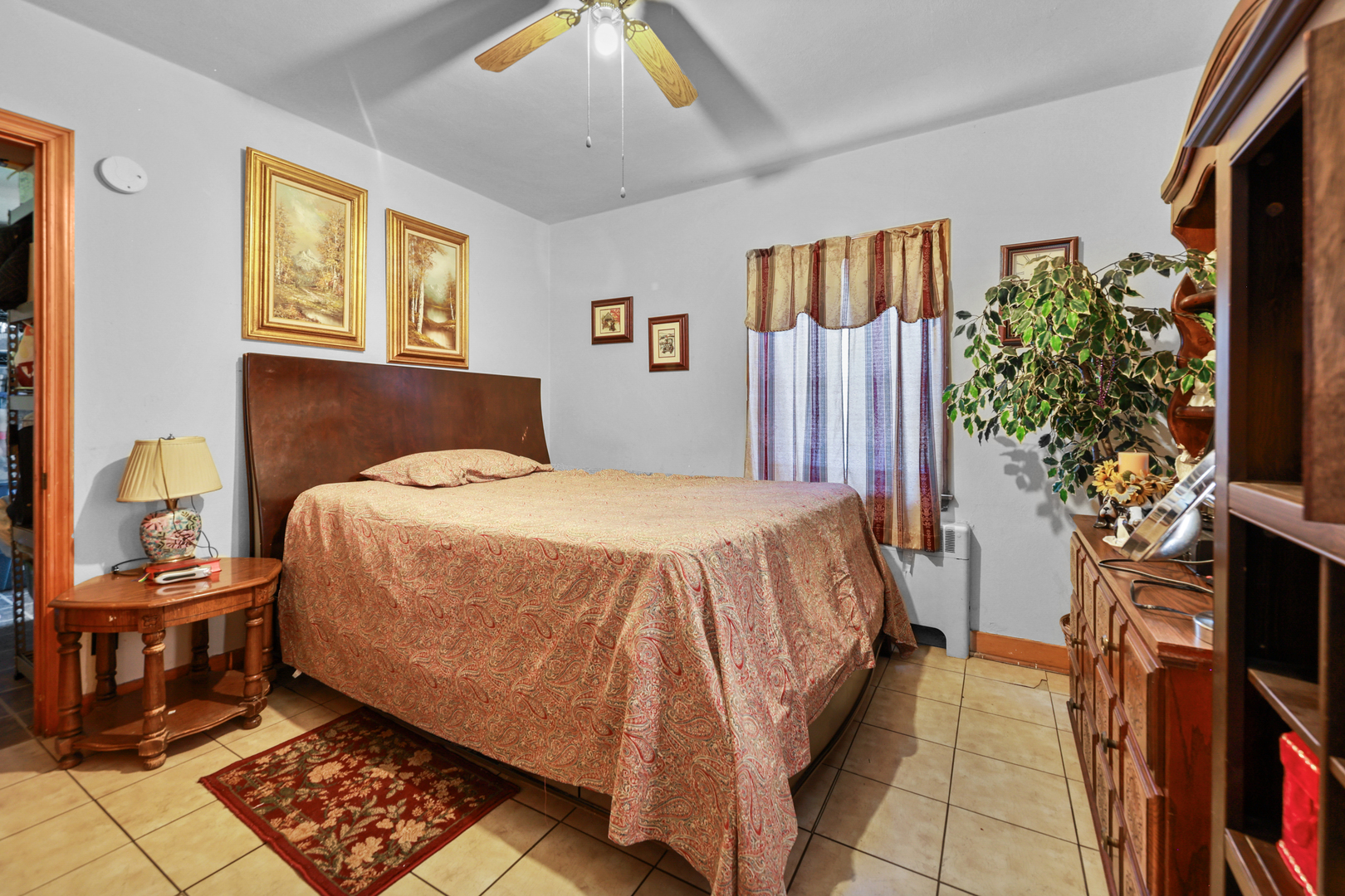 605 East Street Mazon, IL 60444 - Photo 15 of 28 a bed sitting in a bedroom next to a window with potted plants