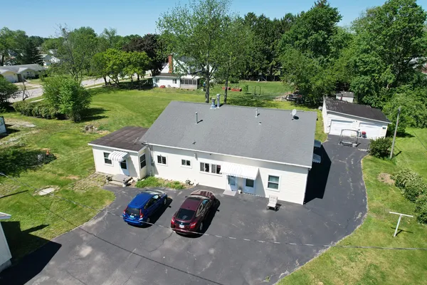an aerial view of a house with garden space and street view