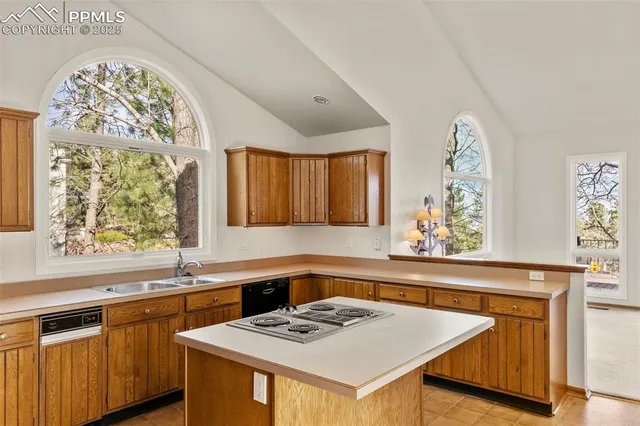 a kitchen that has a sink and a stove in it