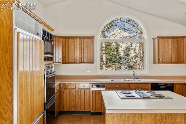 a kitchen with a stove a sink and a refrigerator