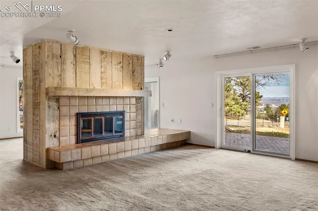 a view of a livingroom with an empty space and a fireplace