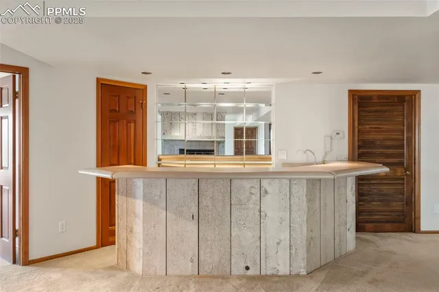 a large white kitchen with granite countertop a sink