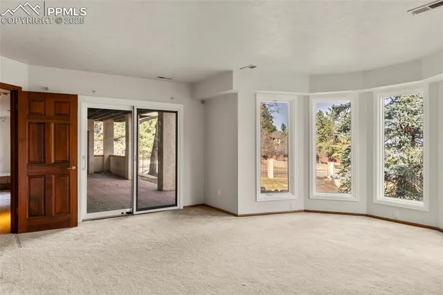 an empty room with windows and closet