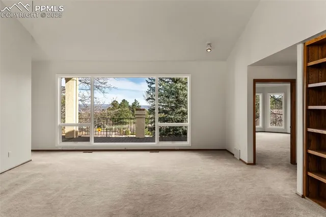 an empty room with large windows