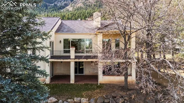 a aerial view of a house with large trees