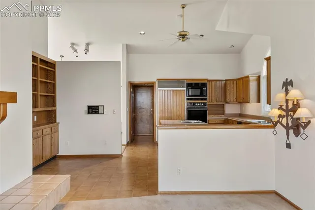 a kitchen with stainless steel appliances granite countertop a refrigerator and a stove