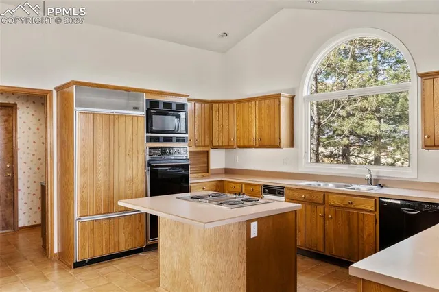 a kitchen that has a sink and a stove