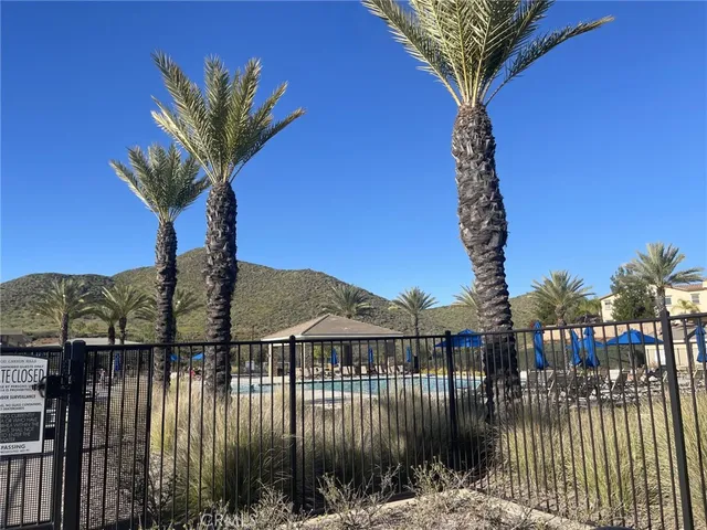 a front view of a house with a yard and potted plants