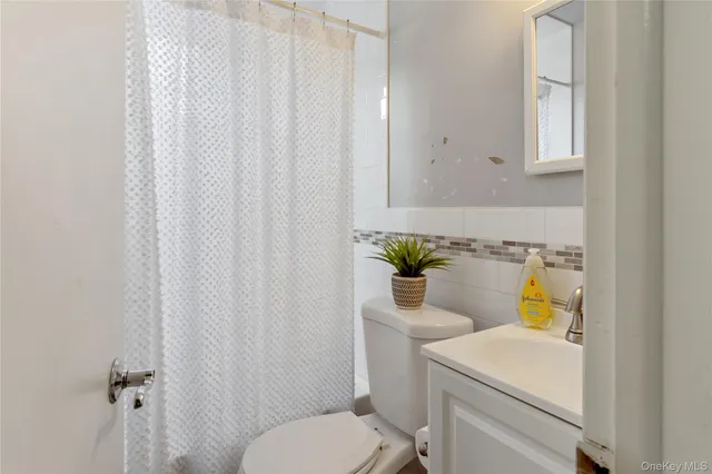 a bed sitting in a bedroom next to a window and dresser