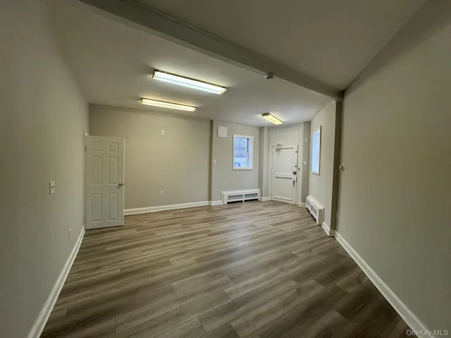 a bathroom with a sink and mirror with toilet