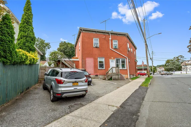a view of a car park in front of a house