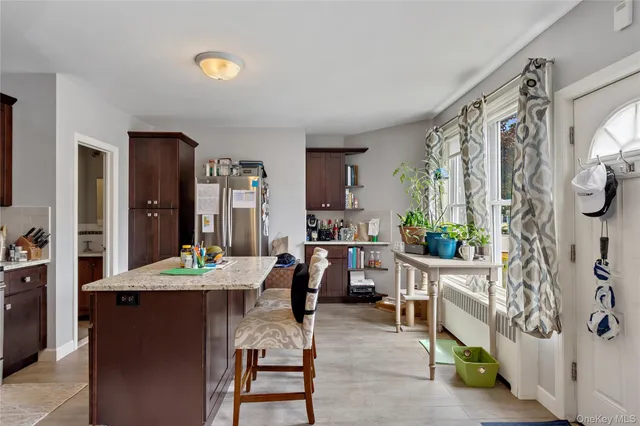 a view of a dining room with furniture and a potted plant