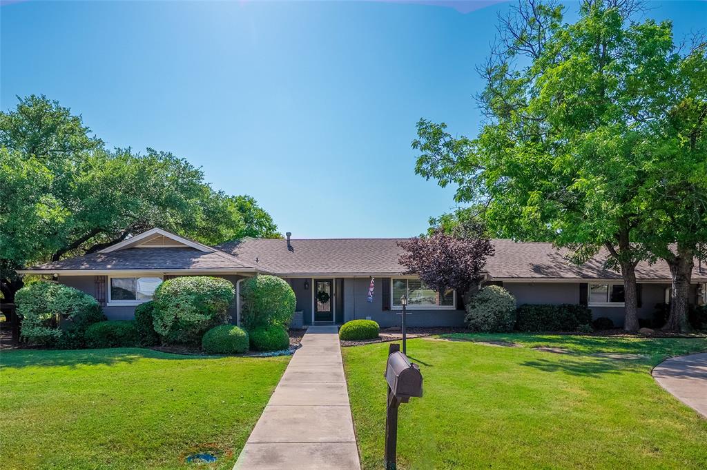 Single story home with a front lawn and roof with shingles
