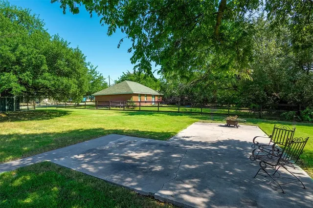 a view of outdoor space with swimming pool and green space