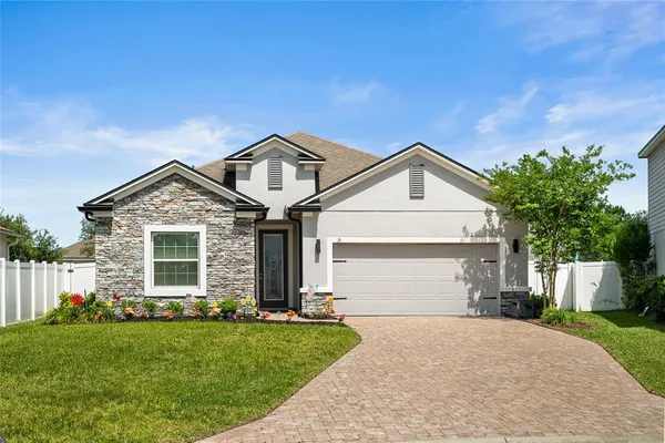 a front view of a house with a yard and garage