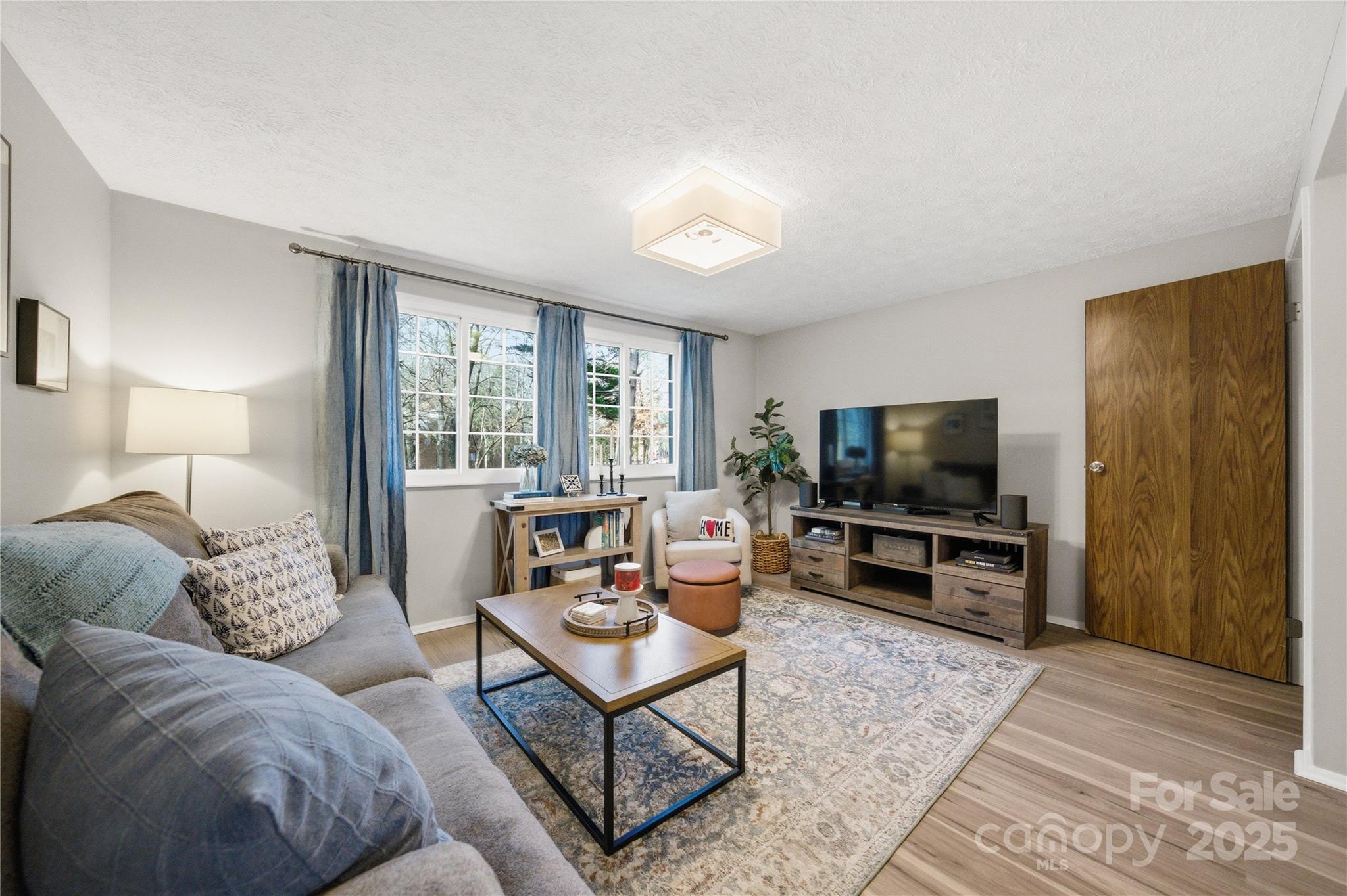 1235 Scaleybark Road, Unit C Charlotte, NC 28209 - Photo 11 of 33 a living room with furniture and a flat screen tv