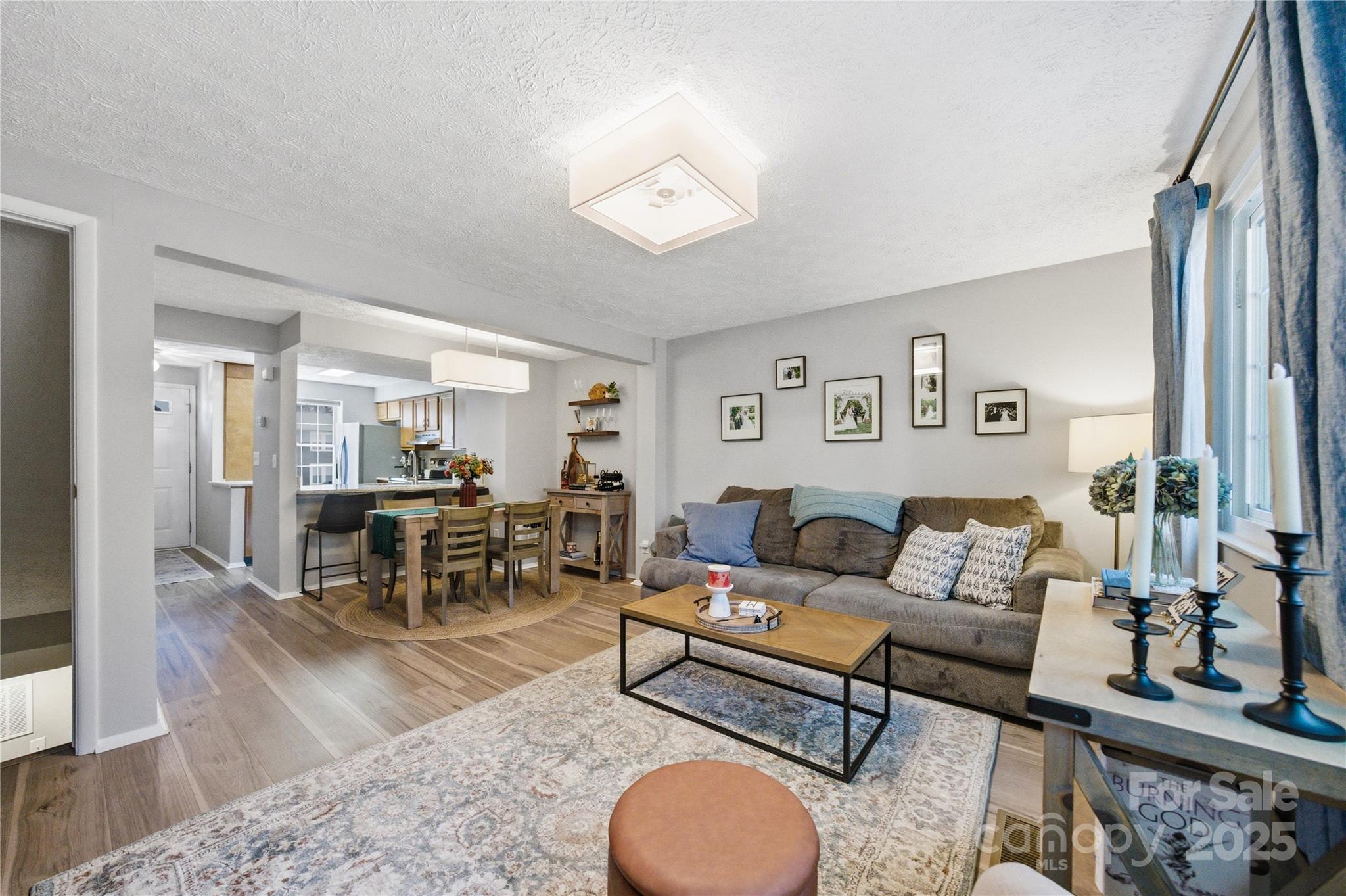 1235 Scaleybark Road, Unit C Charlotte, NC 28209 - Photo 13 of 33 a living room with furniture a rug and a table