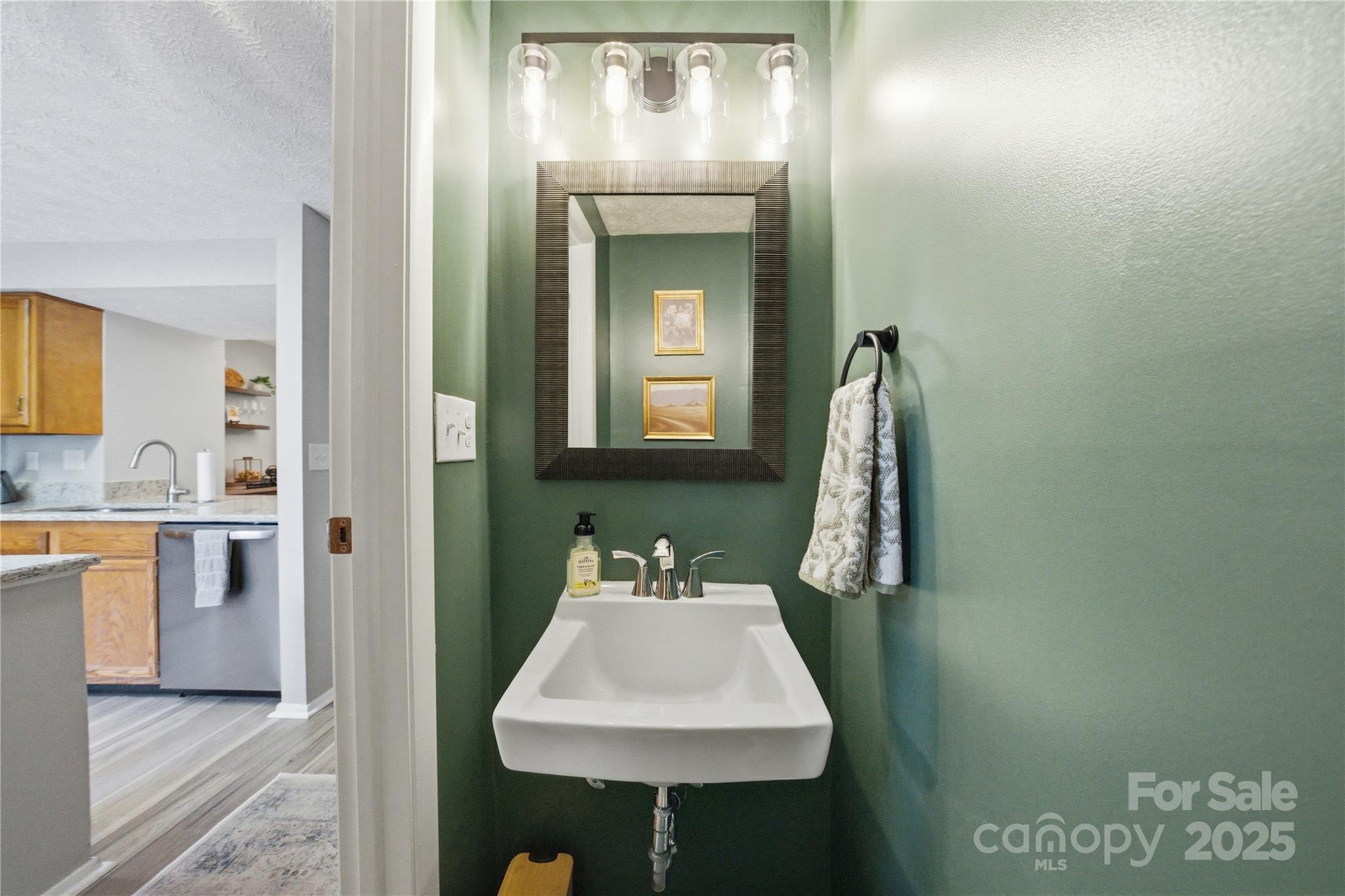 1235 Scaleybark Road, Unit C Charlotte, NC 28209 - Photo 14 of 33 a en suite bathroom with a sink and a mirror