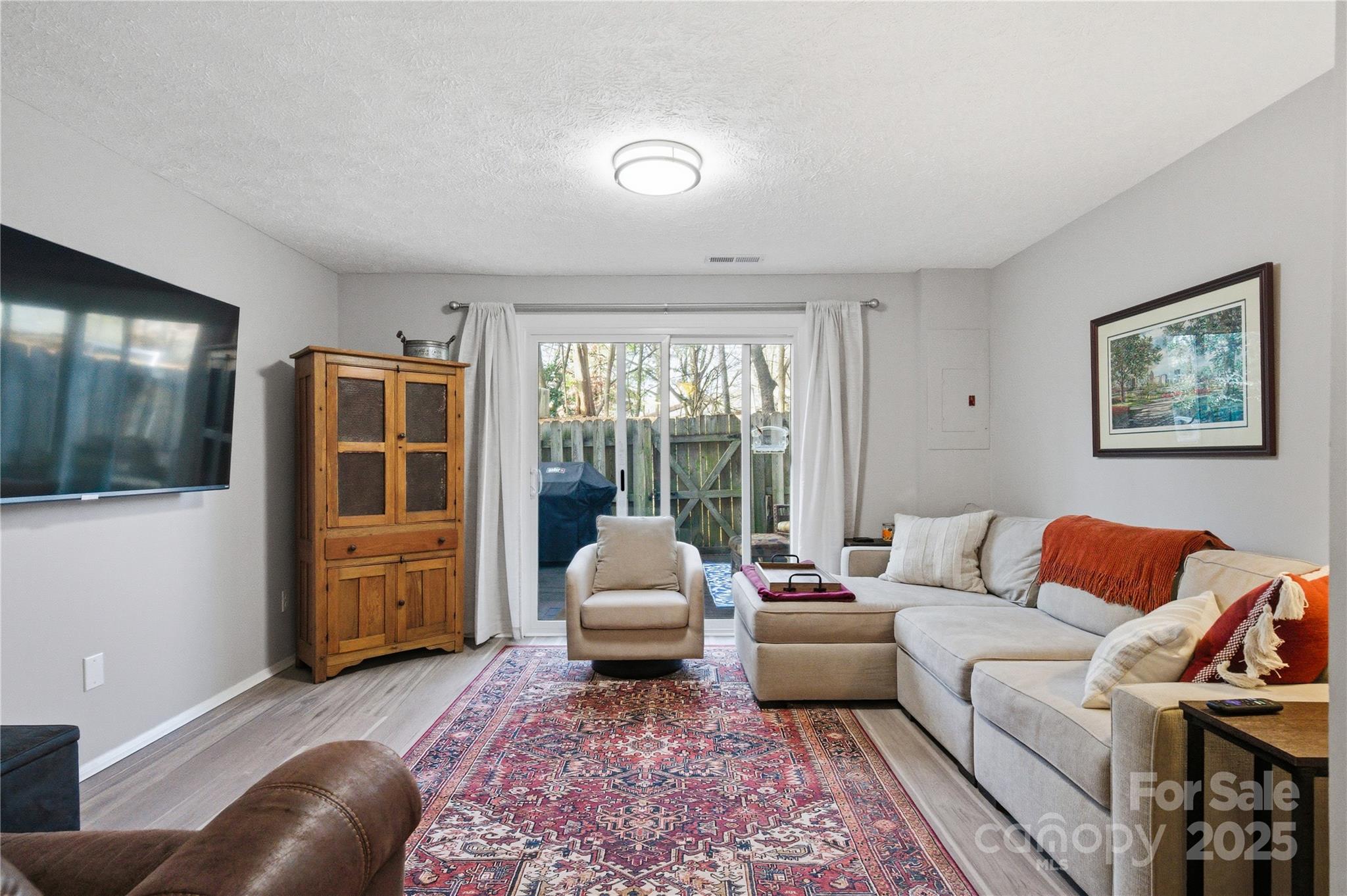 1235 Scaleybark Road, Unit C Charlotte, NC 28209 - Photo 21 of 33 a living room with furniture and a flat screen tv