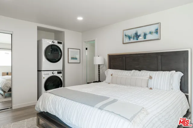 a bedroom with a bed and a painting on the wall