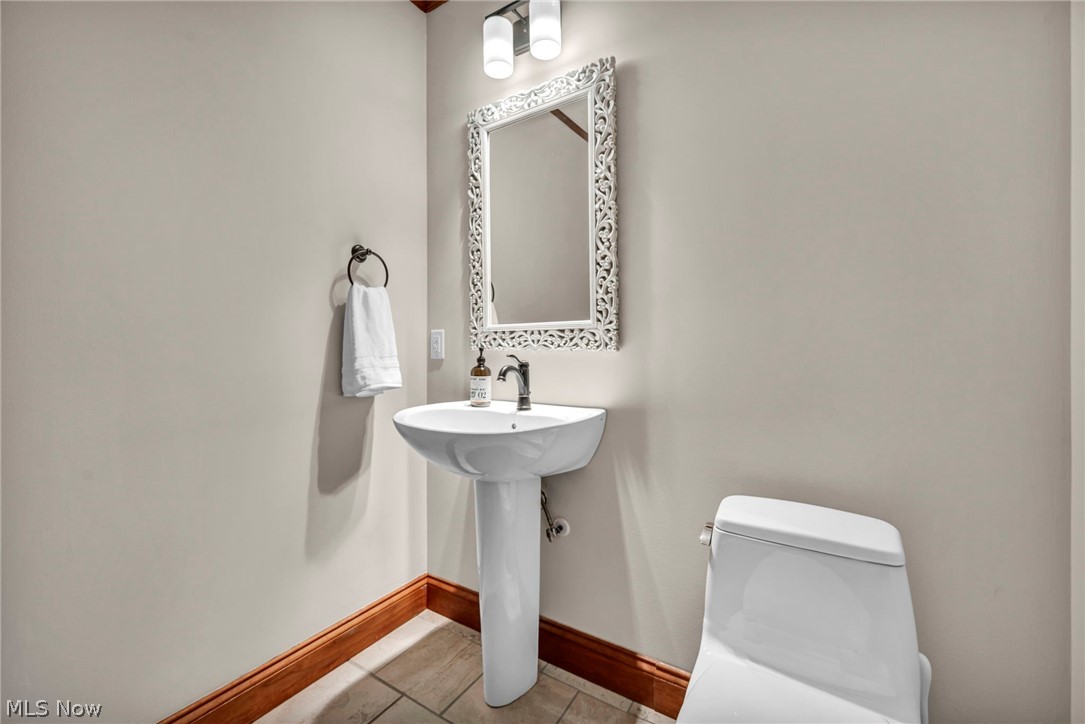 11295 Sutton Place Chardon, OH 44024 - Photo 19 of 50 Half bathroom with toilet and light tile patterned floors