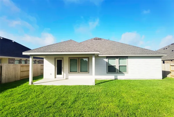 a front view of a house with a yard and potted plants