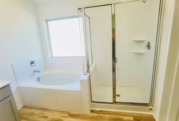 a bathroom with a bathtub and a shower
