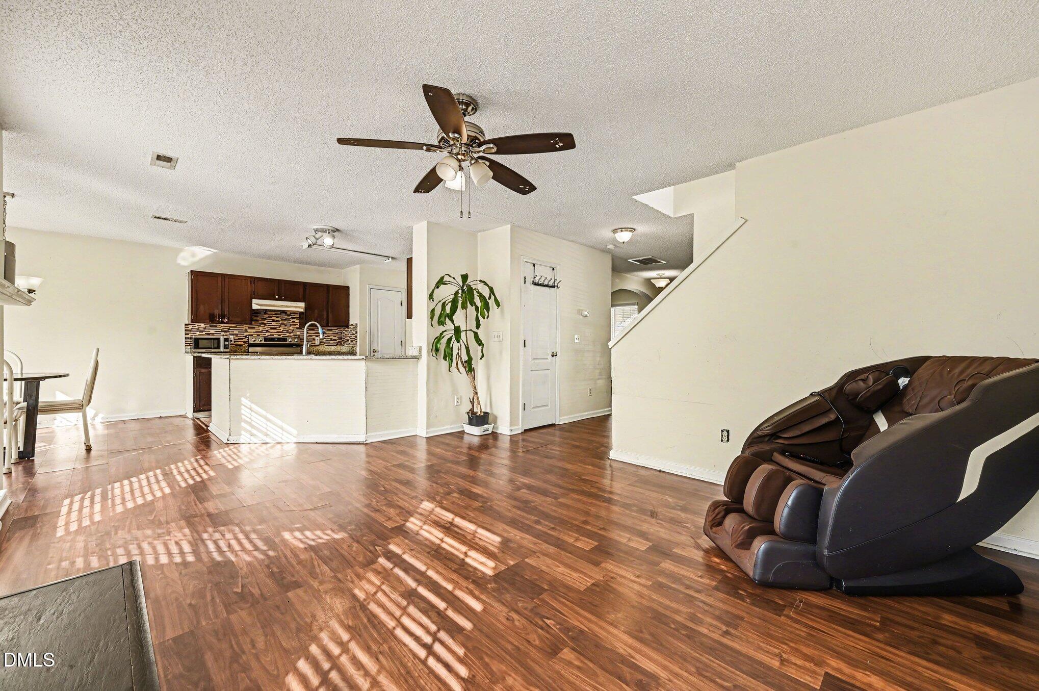 5115 Cardinal Grove Boulevard Raleigh, NC 27616 - Photo 9 of 36 a living room with furniture and a wooden floor