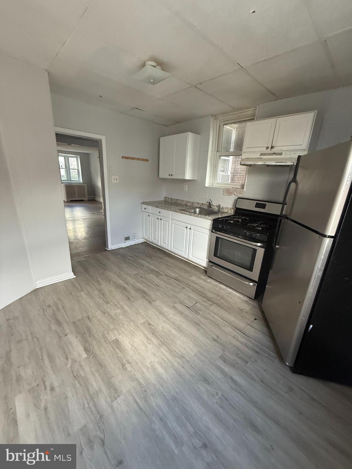 149 Springton Road Upper Darby, PA 19082 - Photo 11 of 31 a open kitchen with cabinets stove and wooden floor