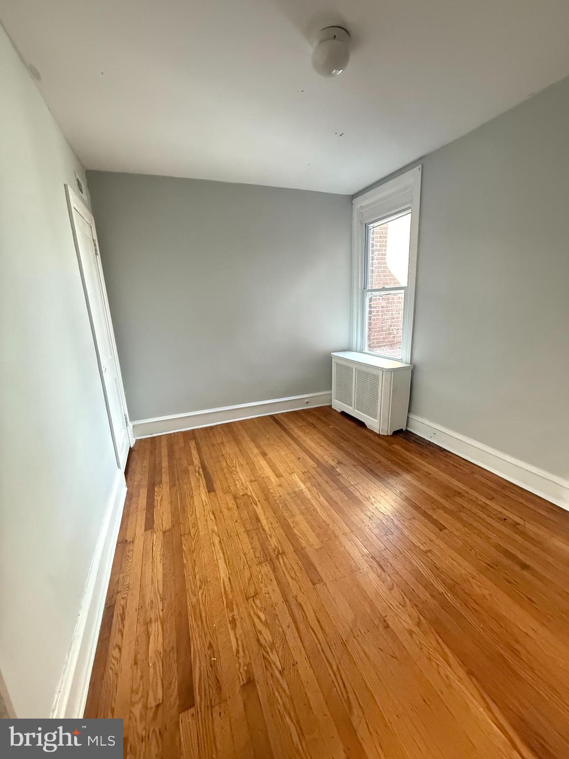 149 Springton Road Upper Darby, PA 19082 - Photo 12 of 31 an empty room with wooden floor and windows
