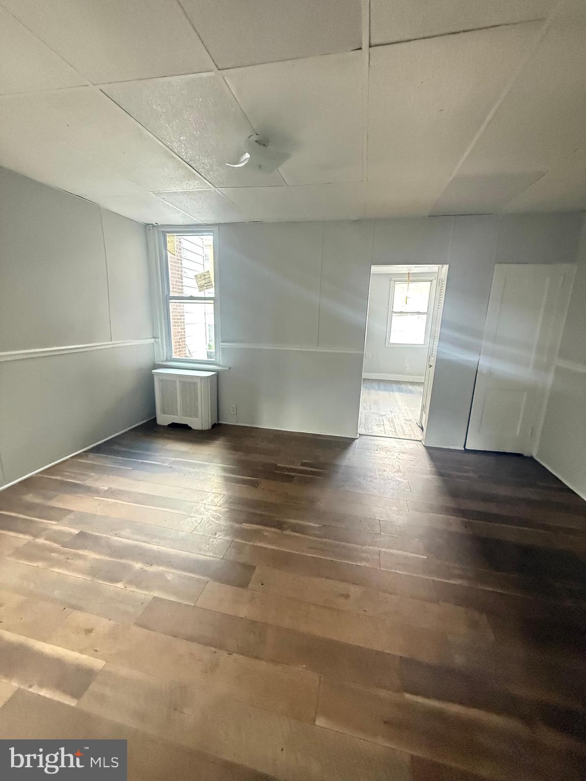 149 Springton Road Upper Darby, PA 19082 - Photo 16 of 31 a view of empty room with wooden floor and fan