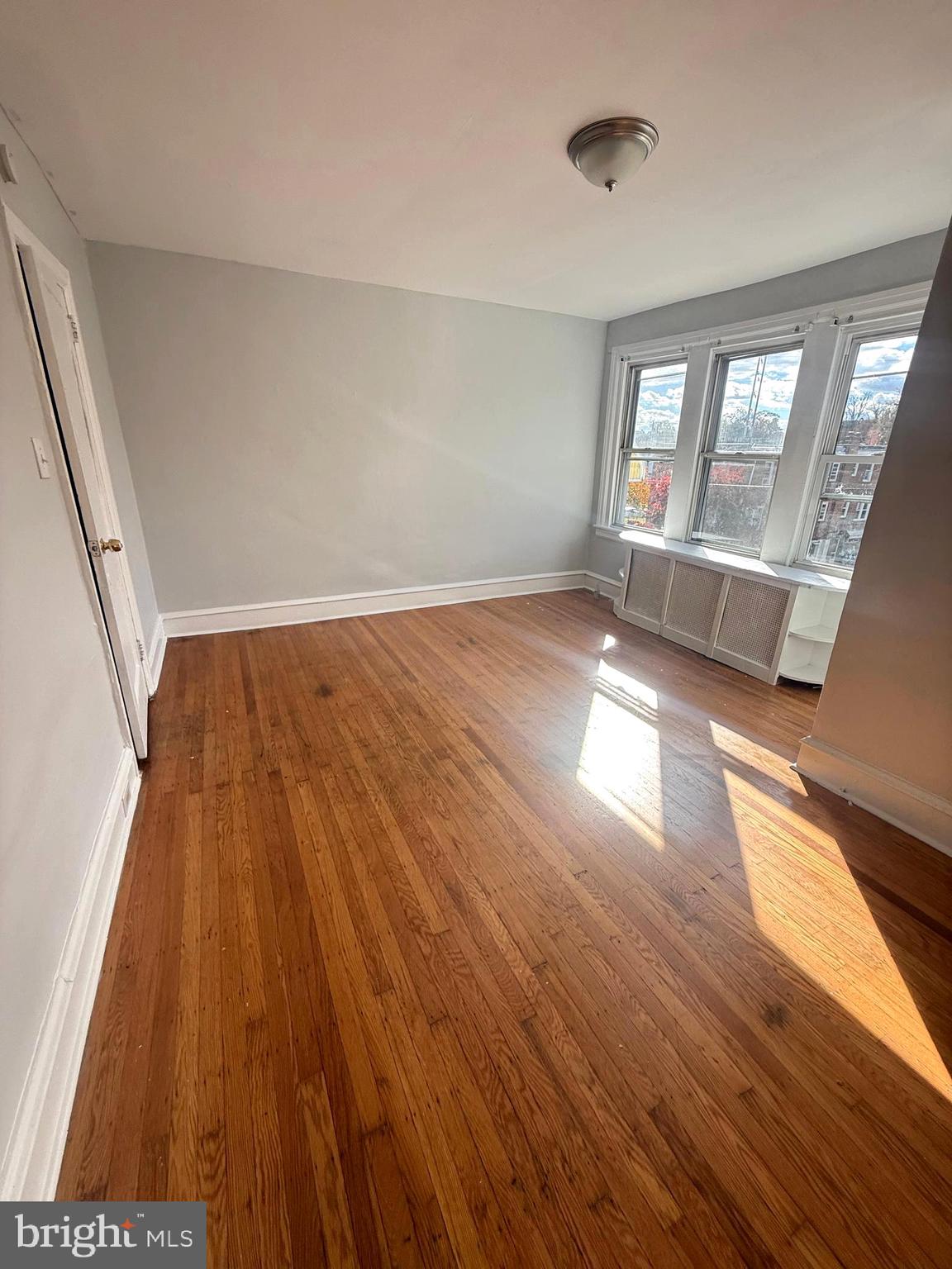 149 Springton Road Upper Darby, PA 19082 - Photo 24 of 31 wooden floor in an empty room with a window