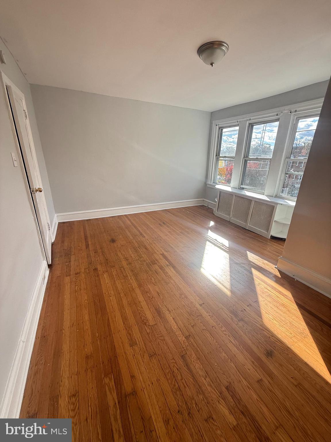 149 Springton Road Upper Darby, PA 19082 - Photo 8 of 31 wooden floor in an empty room with a window
