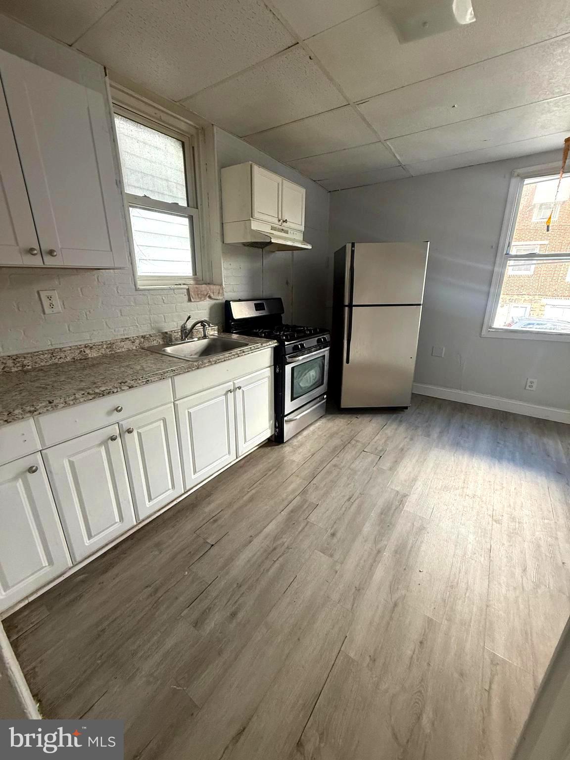 149 Springton Road Upper Darby, PA 19082 - Photo 9 of 31 a kitchen with granite countertop a stove a sink and a refrigerator