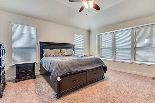 a spacious bedroom with a bed and a large window