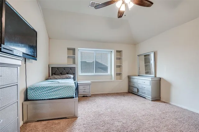 a room that has a bed and a television in it