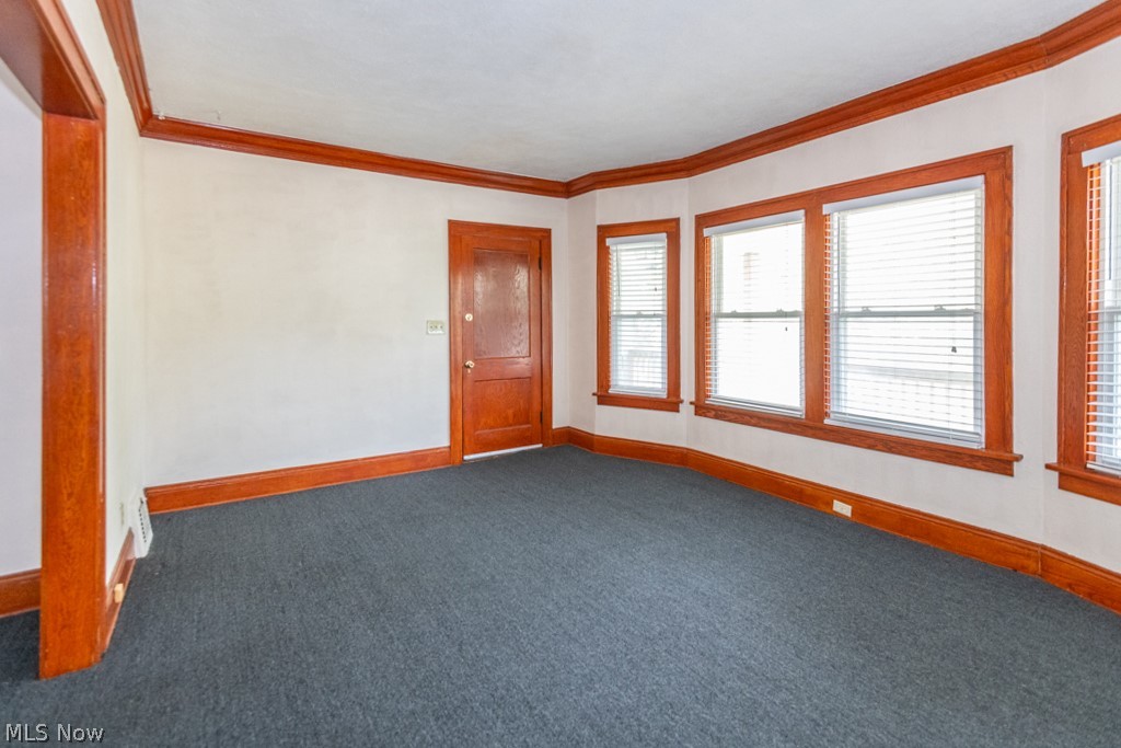 917 Helmsdale Road Cleveland Heights, OH 44112 - Photo 3 of 28 Empty room featuring ornamental molding and carpet floors