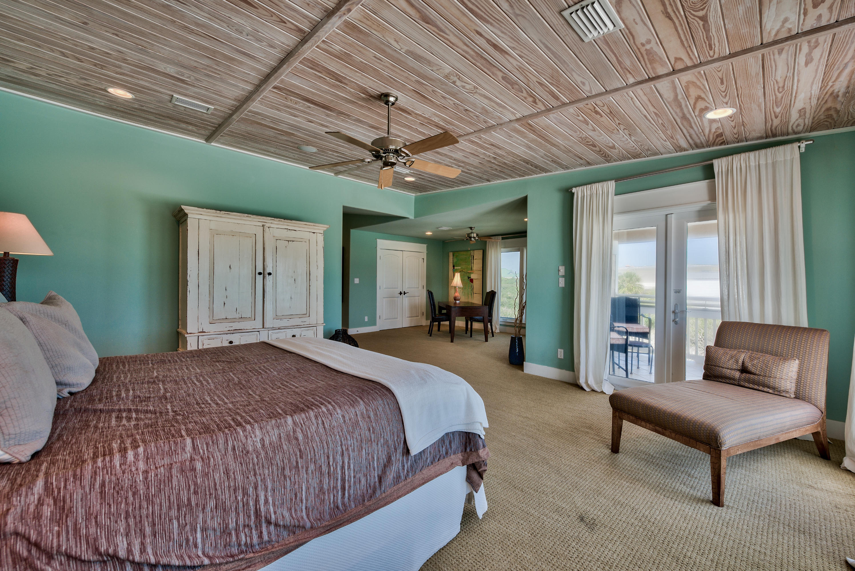 179 Pelican Circle Seacrest, FL 32461 - Photo 20 of 94 a spacious bedroom with a bed a table and chair